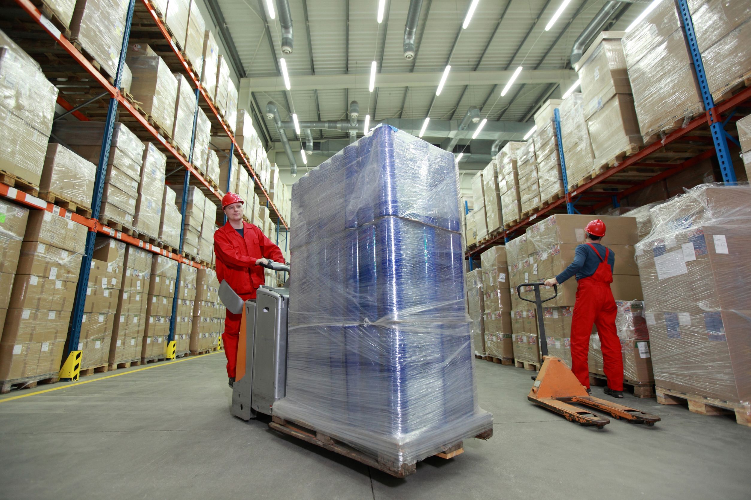 14526373 - two workers in uniforms and safety helmets working in storehouse